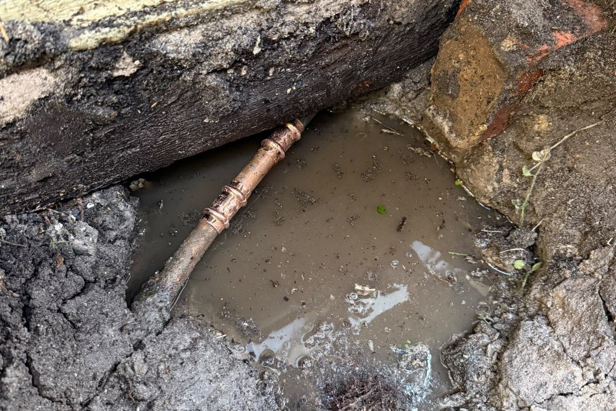 Excavated burst copper water pipe leaking beside a Melbourne home foundation